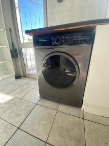 a washing machine sitting on the floor in a kitchen at House Grace in Gqeberha