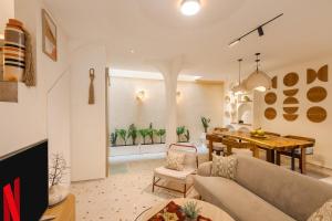 a living room with a couch and a dining table at The Shalak Villa Bali in Denpasar