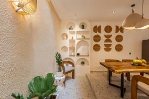a dining room with a wooden table and a dining room at The Shalak Villa Bali in Denpasar