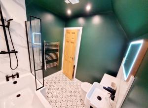 a green bathroom with a toilet and a sink at Perfect Base for Work or Leisure Unique Two-Bed in Irlam +58 photos