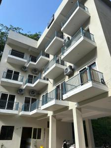 a building with balconies on the side of it at Hotel Abline Rishikesh in Rishīkesh +44 photos