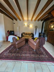 a living room with two chairs and a couch at Gite cosycool in Languidic