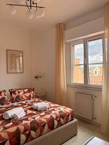 a bedroom with a bed and a window at Be Your Home - Cruise Stop Guest House in Civitavecchia