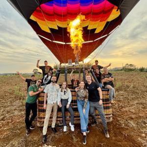 a group of people standing in front of a hot air balloon at Hotel Centro dos Canyons in Praia Grande +22 photos