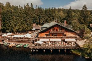 an aerial view of a building on the water at Hotel Am Fichtelsee in Fichtelberg