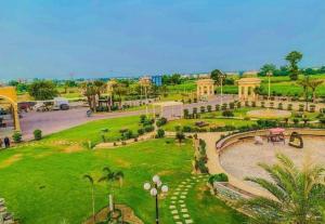 a park in a city with trees and grass at The Comfy Cottages in Faisalabad