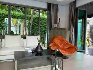 un salon avec un canapé et une table dans l'établissement Luxury Pool Villa Resort Style Near Laguna Area, à Laguna Phuket