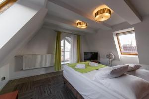 a bedroom with a large bed and a television at Hotel Artus - Old Town in Gdańsk +75 photos