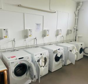 a laundry room with four washing machines in it at Ferienstube alte Teestube Norderney in Norderney