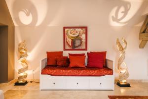 a white bed with red pillows in a room at Gîte du Dreuillet Charme & nature en Sologne in La Celle-sous-Gouzon +15 photos