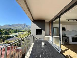 a balcony with a view of the mountains at Urban Escape - Le Jardin Unit 301 in George +14 photos