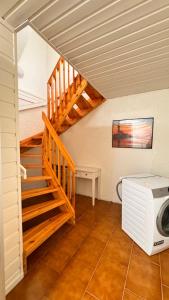 a room with a staircase and a microwave at Rørvikjordet 12 flott hus ved utsikt in Drammen