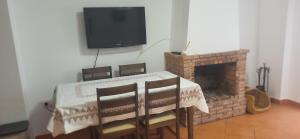 a dining room with a table and a fireplace at Casa Curro in Benaocaz