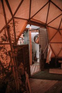 an inside view of a yurt with a door at Dollinco Lodge in El Cerrillo