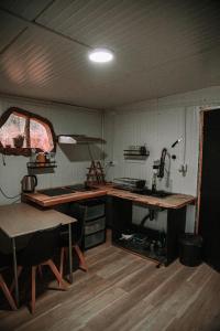 a kitchen with a counter and a table in a room at Dollinco Lodge in El Cerrillo