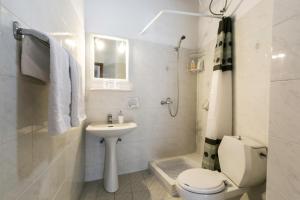 a white bathroom with a toilet and a sink at Evdokia Old Town Hotel in Rhodes Town