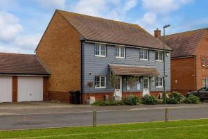 a house with a gray house at Coastal Home for 6 in The Witterings in East Wittering