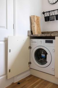 a washing machine in a kitchen with a counter at Coastal Home for 6 in The Witterings in East Wittering +43 photos