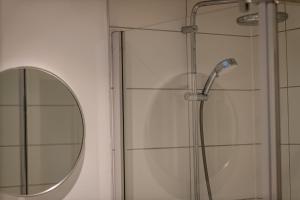 a shower with a glass door and a mirror at Murray's Neuk in Anstruther +24 photos