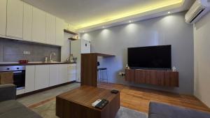 a living room with a flat screen tv on a wall at Bijeljina Central in Bijeljina