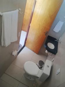 a small bathroom with a toilet and a shower at Pousada Apart Praia Uruaú in Beberibe +6 photos