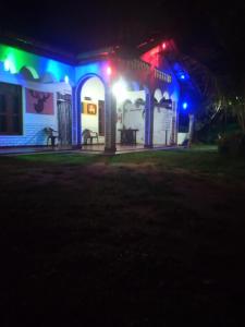 a house with lights on it at night at Sigiriya Lions Rest Hostel in Sigiriya