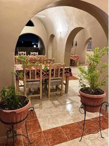 a dining room with a table and potted plants at Kareem Hotel Luxor in Luxor +90 photos