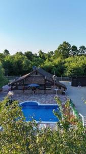 a swimming pool with a slide and a playground at Ranč Lipe in Orašje
