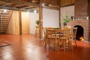a dining room with a table and chairs and a fireplace at The Flow Homestay in Sapa