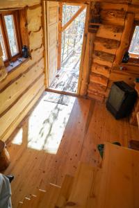 an inside view of a wooden cabin with a window at Domek Baby Jagi Prawdziwy Survival  +15 photos