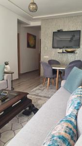 a living room with a couch and a table at HEAVEN BEACH in Sidi Rahal