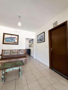 a room with a door and a bench and a tile floor at Estrela D Alva Pousada in Pirenópolis +56 photos