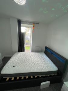 a bed in a room with a window at Double room homestay in Reading