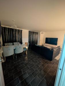 a living room with a couch and a bed at Double room homestay in Reading