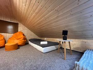 a room with two beds and a table in it at Relax Centrum Gól in Loučná nad Desnou