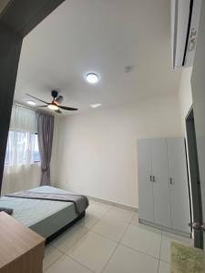 a bedroom with a bed and a ceiling fan at Traders park Balakong 3 room Wi-Fi balcony unblock view in Cheras +18 photos