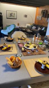 a table with a bunch of food on it at Le Lézard et la Grenouille BnB in Ovronnaz