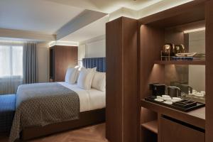 una habitación de hotel con una cama y un espejo en MIM Andorra Member of Melia Collection, en Escaldes-Engordany 29 fotos más