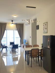 a kitchen and dining room with a table and chairs at Traders park Balakong 3 room Wi-Fi balcony unblock view in Cheras
