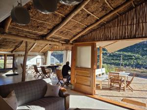 a living room with a couch and a table and chairs at Oudrif Strawbale Retreat in Clanwilliam