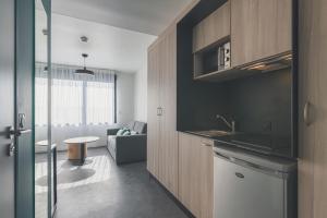 a room with a kitchen and a living room at Whoo Bordeaux Bacalan - Hostel in Bordeaux