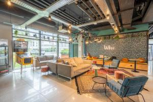 a living room with couches and chairs and a table at Whoo Bordeaux Bacalan - Hostel in Bordeaux