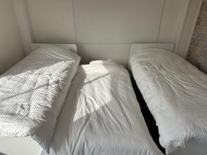 two beds sitting next to each other in a room at とまるん桜山 in Nagoya +4 photos