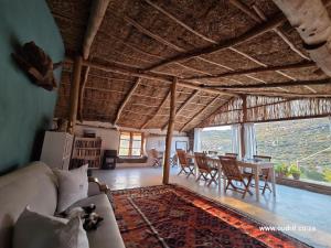 a living room with a couch and a table at Oudrif Strawbale Retreat in Clanwilliam