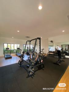 a gym with tread machines and a man in the background at Traders park Balakong 3 room Wi-Fi balcony unblock view in Cheras