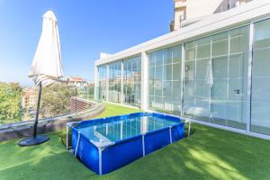 an indoor swimming pool on the balcony of a building at GlassHaus Rooftop 2-BR W Pool & Terrace in Ghazir in Admā