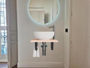 a bathroom with a sink and a mirror on the wall at Global Adriano luxury 1 in Seville