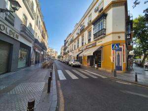 a city street with buildings and a car on the road at Global Adriano luxury 1 in Seville