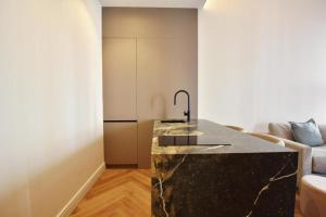 a kitchen with a marble counter in a living room at Global Adriano luxury 1 in Seville