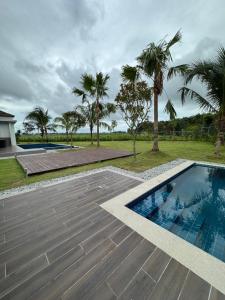 an image of a swimming pool with palm trees at The Mangrove at Carey Circles 